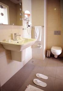 a bathroom with a sink and a toilet at Hotel Davos Istanbul in Istanbul