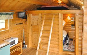 a log cabin with a bunk bed and a ladder at 2 Bedroom Lovely Home In Sunne in Sunne