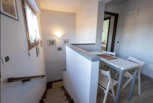 a room with a table and chairs and a staircase at Appartamento in villa con giardino a 300m dal Lago Maggiore in Castelletto sopra Ticino