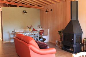 a living room with a fireplace and a table at Eco Urbion in Duruelo de la Sierra