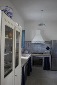 a kitchen with a sink and a stove at Ca' del Sale 97 in Marsala