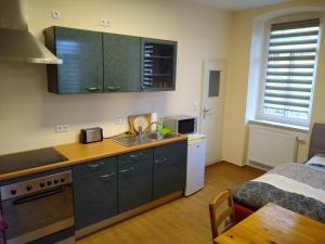 a kitchen with a sink and a counter top at Ferienwohnung Schleich in Starkenberg