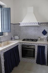 a kitchen with a sink and a stove top oven at Ca' del Sale 97 in Marsala