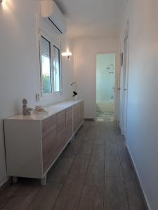 a bathroom with a sink and a mirror on the wall at Villa voor 8 personen met zwembad in Calafat