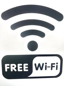a sign that says free wifi on a white background at BalticApart Riga in Rīga
