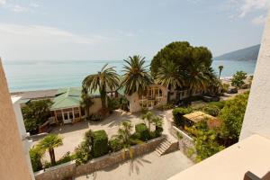 an aerial view of a resort with palm trees and the ocean at Old Gagra Hotel in Gagra