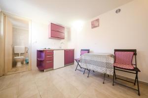 a kitchen with a table and chairs in a room at Holiday Home Ana in Poljana