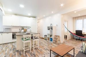 a kitchen with white cabinets and a hammock in a room at Gran Bilbao VI by Aston Rentals in Barakaldo