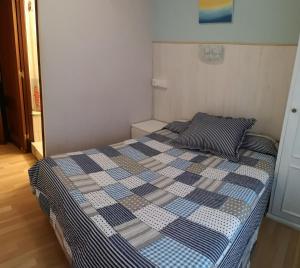 A bed or beds in a room at Hostal Campoamor