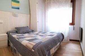 A bed or beds in a room at Hostal Campoamor