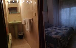 A bed or beds in a room at Hostal Campoamor