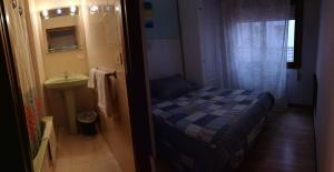 A bed or beds in a room at Hostal Campoamor