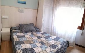 A bed or beds in a room at Hostal Campoamor