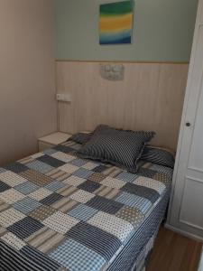 A bed or beds in a room at Hostal Campoamor