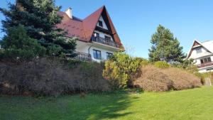 a large house sitting on top of a lush green field at DOM KKK in Rabka