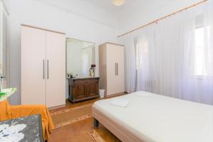 a bedroom with a bed and a dresser in it at Veranda Rooms in Dubrovnik