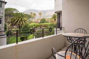 a balcony with a table and chairs and a view at Albany Twelve in Cape Town