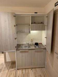 a small kitchen with a sink and a counter at Alloggio Casa Talvena Longarone in Longarone