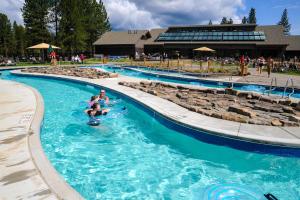 a group of people in a pool at a resort at Meadow House 15 | Discover Sunriver in Sunriver