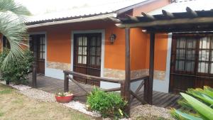 a house with a wooden deck in front of it at ITALIA RANCH in Punta del Este