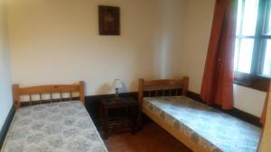 a room with two beds and a table and a window at ITALIA RANCH in Punta del Este +10 photos