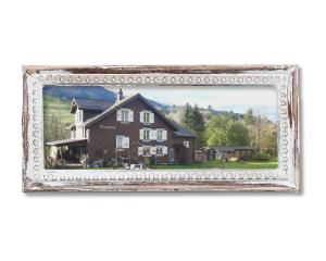 a picture of a house in a picture frame at Studio Chic Wildhaus in Wildhaus