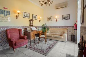a living room with a desk and a couch and a table at Solar de Mos in Lagos