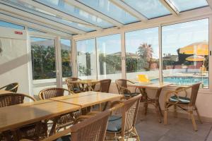 a patio with tables and chairs and a swimming pool at Solar de Mos in Lagos