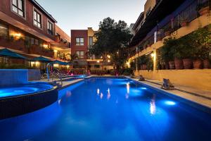 a large swimming pool with blue water in a building at El Pueblito Sayulita - Colorful, Family and Relax Experience with Private Parking and Pool in Sayulita