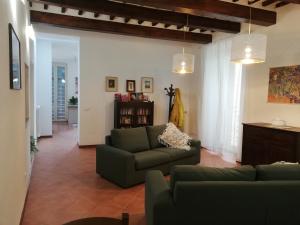 ein Wohnzimmer mit einem Sofa und einem Tisch in der Unterkunft Casa di Pietro Aretino, Arezzo Centro Storico 4-8 letti in Arezzo