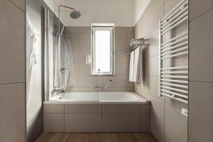 a white bathroom with a tub and a window at Solar de Mos in Lagos