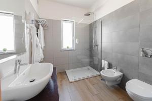 a white bathroom with a sink and a toilet at Solar de Mos in Lagos