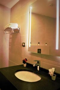 a bathroom with a sink and a mirror at New MerryLand Hotel in Amman