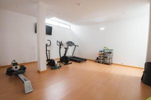 an empty room with treadmills and exercise bikes in it at Solar de Mos in Lagos