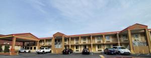 a hotel with cars parked in a parking lot at FairBridge Inn & Suites in McDonough