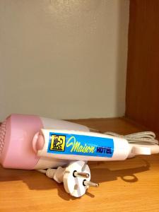 a pink and white toothbrush laying on the floor at MAISON HOTEL in Cauayan City