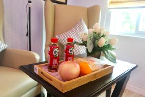 a table with two bottles of soda and fruit on it at MAISON HOTEL in Cauayan City