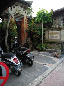 deux motocycles garés devant un bâtiment dans l'établissement Pondok Bulan Mas, à Ubud