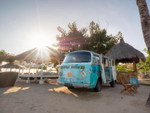 a blue van parked in front of a beach at SOL by Meli&aacute; Benoa Bali All inclusive in Nusa Dua