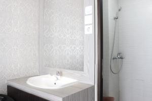 a bathroom with a sink and a shower at Elegant 2BR Gateway Pasteur Apartment near Exit Toll Pasteur By Travelio in Bandung +7 photos