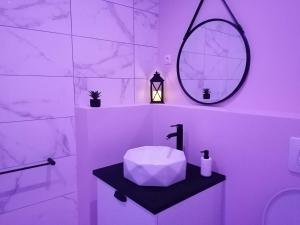 a white bathroom with a sink and a mirror at Jacuzzi Romantique 15 min Etretat 2 in Fécamp +20 photos