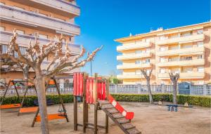 a playground in front of a tall building at Awesome Apartment In Blanes in Blanes