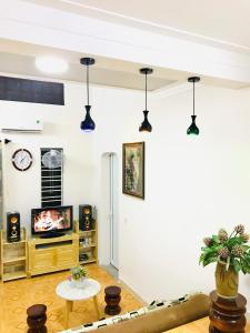 Timothy Homestay Hue في هوى: غرفة معيشة بجدران بيضاء وأضواء سوداء