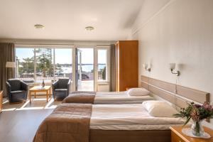 a hotel room with two beds and a balcony at Spa Hotel Kasnäs in Kasnäs +24 photos