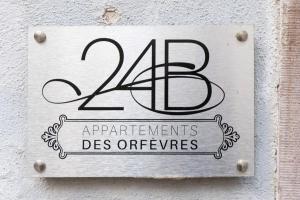 a sign on the side of a building with the number at Appartements Orfèvres Cathédrale in Strasbourg