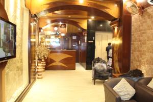a lobby with a couch and a chair in a room at Hotel White House in Kolkata