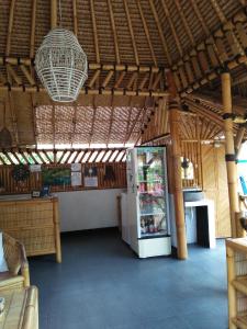 a large room with a refrigerator in a building at Tua Tua Keladi Bungalows in Gili Air