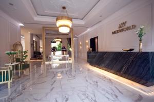 a lobby with a large marble floor and a counter at MEDWORLD Health & Rehabilitation Center Rixos Antalya in Antalya