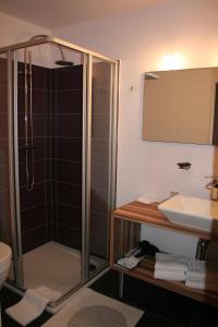 a bathroom with a shower and a sink at Hotel Carpinus in Leuven