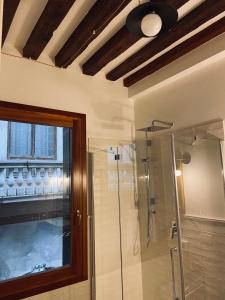 a bathroom with a shower and a glass shower stall at San Marco Romantic Dream in Venice